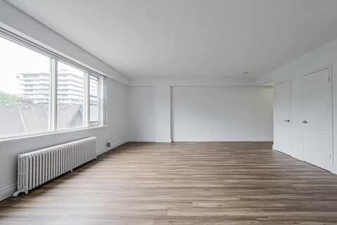 a living room with a large window and wooden floors at 161 St. George, California  